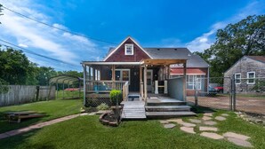 A single-story house with a covered porch, a small front yard with a stepping stone path, and a wooden fence in the background. - Music City House, 4 miles to BDWY, Free Parking (Nashville)