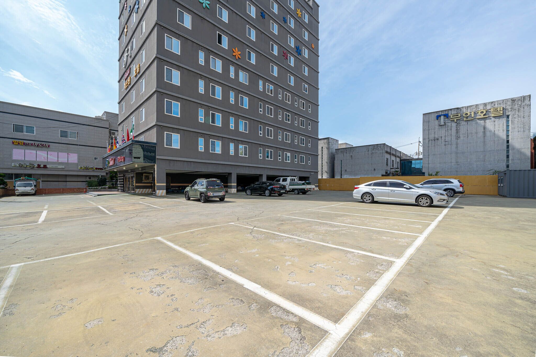 A multi-story parking garage with several cars parked inside.