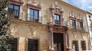 A historic building with ornate architectural details, including columns, balconies, and a large wooden door. - APARTMENT PALACIO DE LOS VIBORA (Lucena)