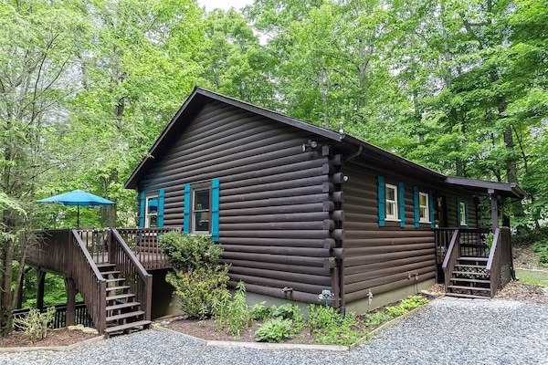 Charming forest cabin with colorful accents and a spacious outdoor decks.