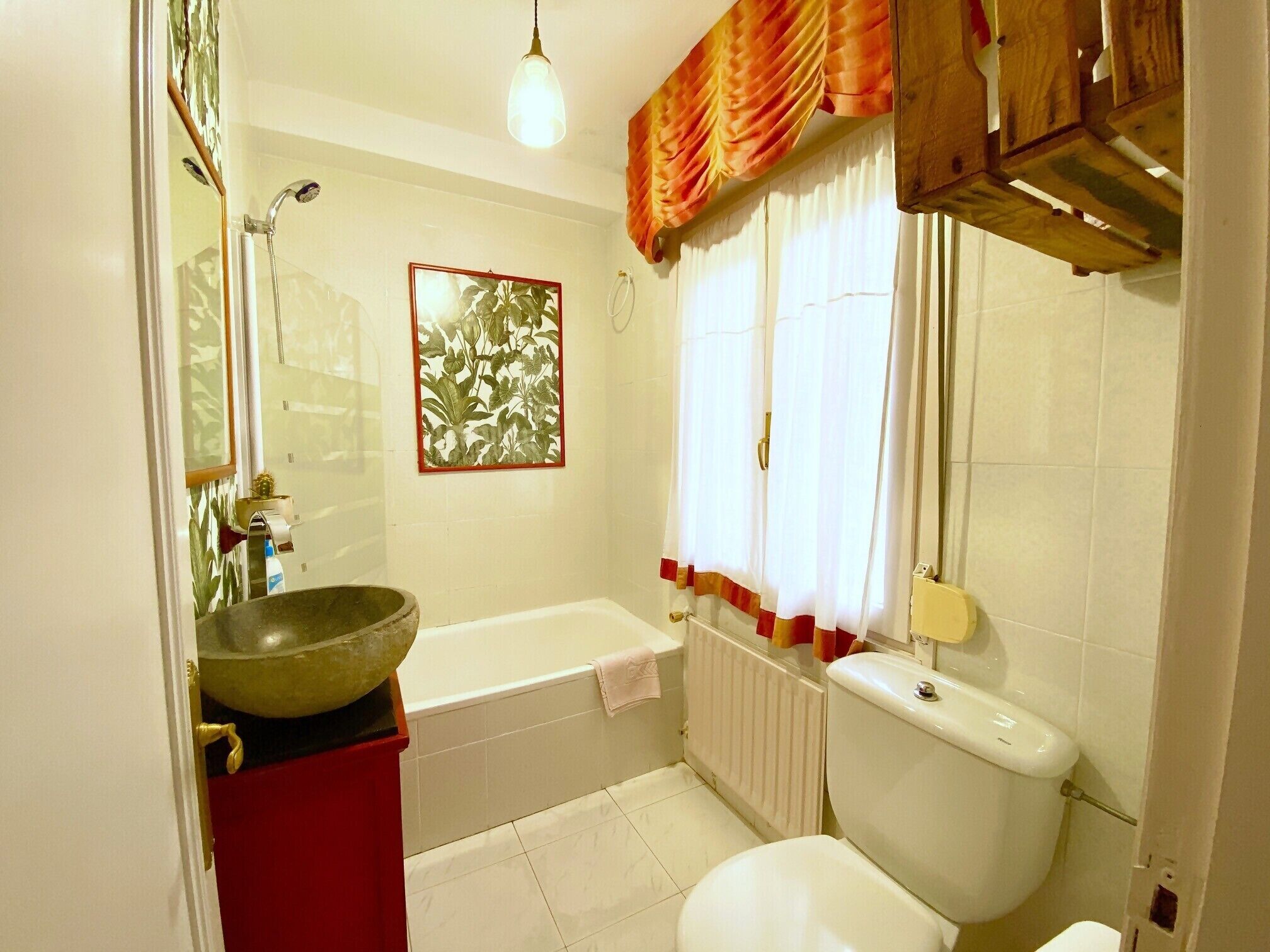 A bathroom with a bathtub, toilet, and sink.