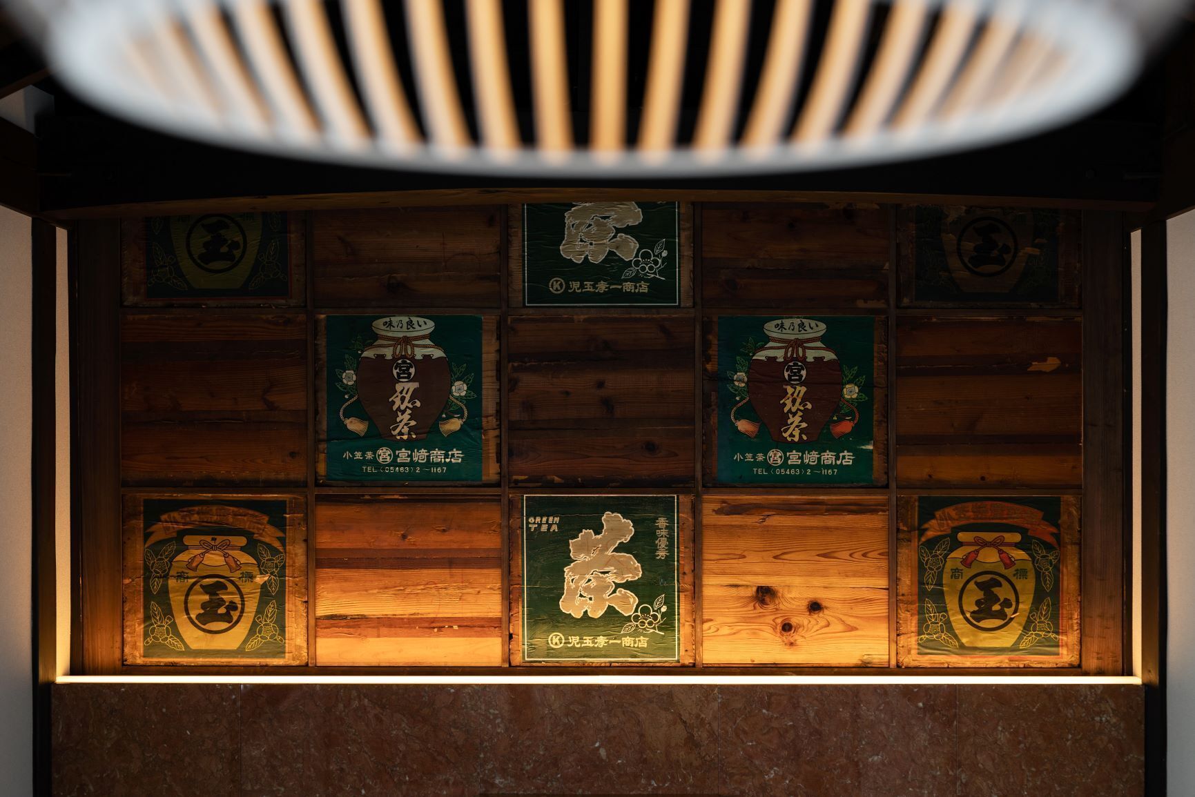 A wooden wall with multiple framed signs, each featuring a logo and some text.