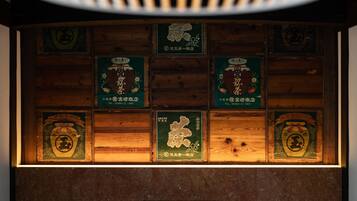 A wooden wall with multiple framed signs, each featuring a logo and some text.