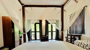A hotel room with a large bed, a desk, and a TV. - The Countryside Udawalawe (Udawalawa)