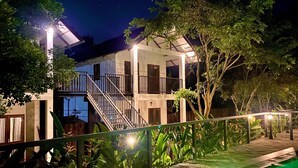 A two-story building with a balcony, surrounded by greenery and a pool area. - The Countryside Udawalawe (Udawalawa)