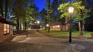 A stone pathway leading to a rustic building with a brick facade and a wooden structure in the background. - Gorgeous home in Gustelnica with sauna (Gustelnica)
