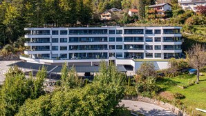 A multi-story hotel with a modern design, featuring balconies and large windows.