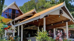 A building with a sloped roof, large windows, and a sign reading "Welcome Chocolate Lovers". - Honiara Hotel (Honiara)