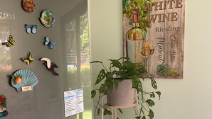 A kitchen with a refrigerator, decorative magnets, a potted plant, and a wall-mounted sign. - Tranquil Beachside Retreat With Private Pool in Garabito (Tárcoles)