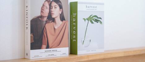 Two books titled 'KINFOLK' and 'harvest' on a shelf.