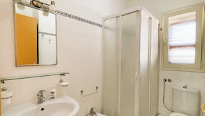 A bathroom with a sink, bidet, toilet, and a shower stall. - Apartment B6 third row first floor (Fondo Morte)