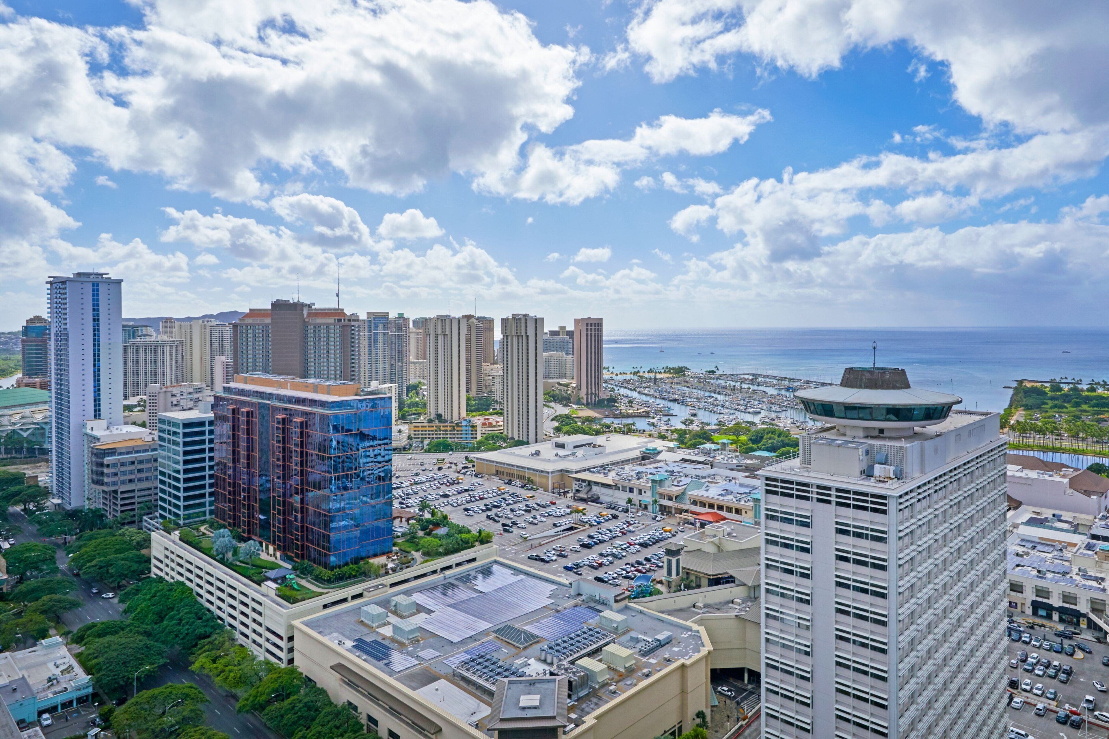 A cityscape with high-rise buildings, a marina, and a clear sky.