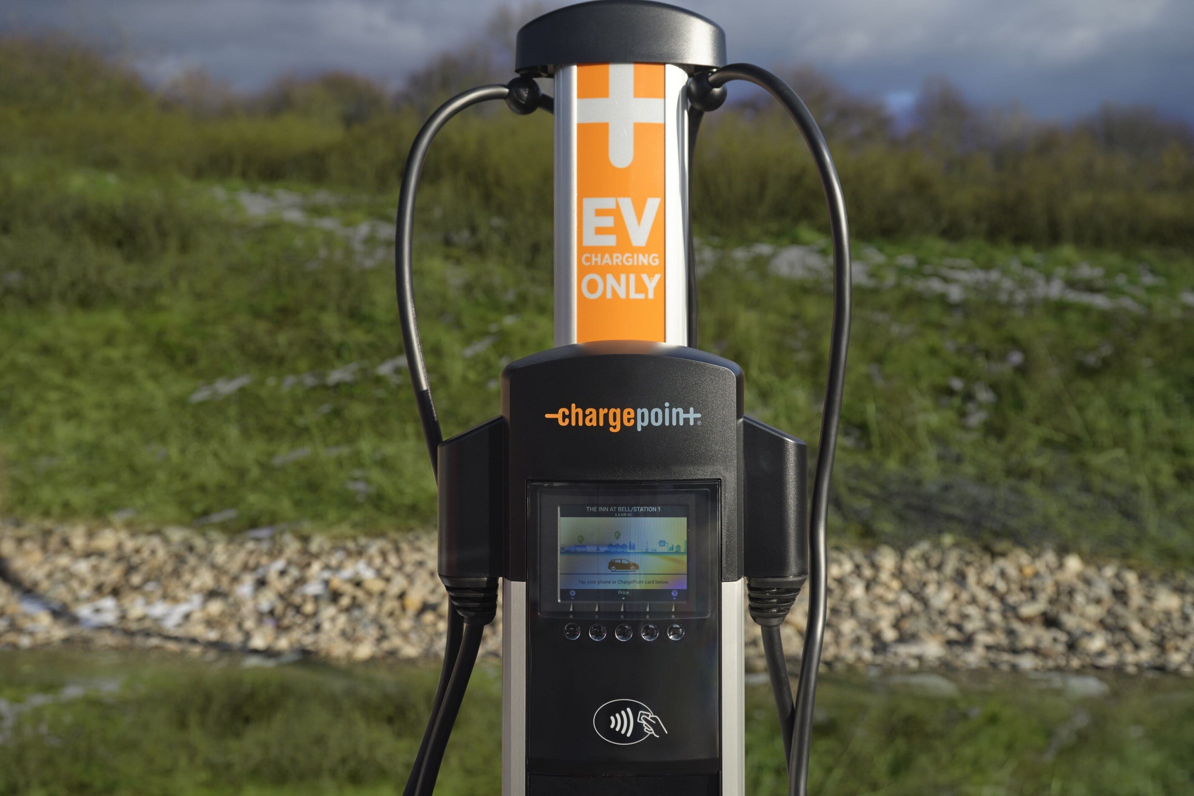 An EV charging station with a digital display, branded with 'chargepoint+' and labeled 'EV CHARGING ONLY'.