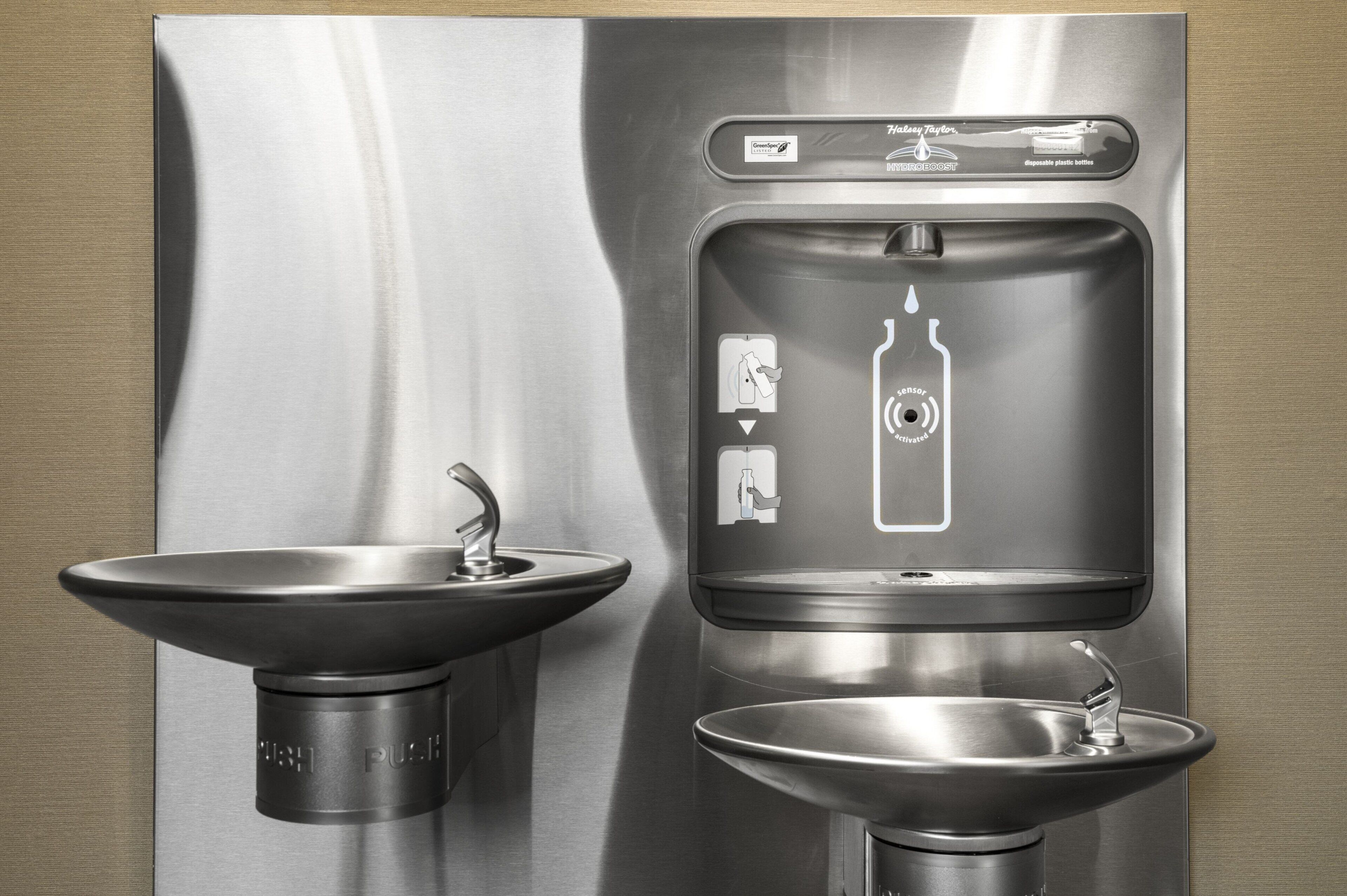 A stainless steel sink and a water dispenser with a bottle icon, indicating a beverage option.