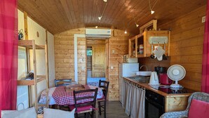 A cozy cabin interior with a dining area, kitchen, and seating space.