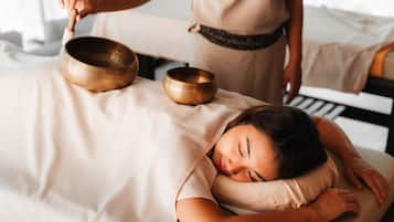 Experience relaxation and rejuvenation in this serene space, featuring a massage table and a multi-purpose bed.