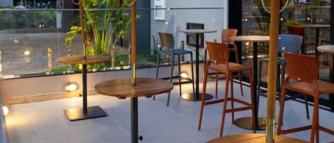 Outdoor seating with umbrellas, tables, and chairs.