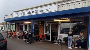 A TRUNCH CAFE & RESTAURANT with outdoor seating and a menu board visible. - Chapel St Leonards Happy Days Beachfield (Mablethorpe)