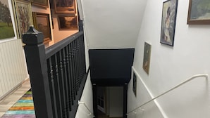 A staircase with a black handrail and a wooden floor. - Local tax 3 Eur Guest for Night (Semmering)
