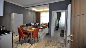 A compact living space with a kitchen, dining area, and a bedroom. - Arpaçay Apart Otel (Arpaçay)