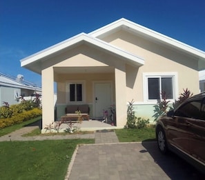 A single-story house with a front porch, a door, and a window. - Luxury home in Jamaica  (Lucea)