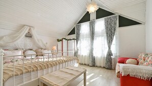 A bedroom with a bed, bench, and a red chair. - Luxurious home in Vucetinec (Vucetinec)