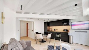 A modern apartment with a living room, dining area, and kitchen. - A Refined 1-BR appartment in Saint-Germain (Paris)