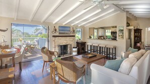A spacious living area with a fireplace, dining table, and comfortable seating.