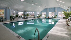 An indoor swimming pool with clear blue water, surrounded by white chairs and potted plants. - Tupelo Bay Villas 314 - Three Bedroom, Two Bath Condo in Golf Community (Garden City Beach)