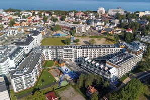 Un hôtel de grande hauteur, avec de nombreux étages, une piscine sur le toit et un espace de jeux pour enfants.