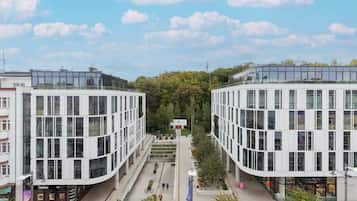 A modern building with a curved facade, large windows, and a central courtyard.