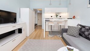 A modern apartment with a kitchen, dining area, and living room.