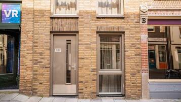 A building with a brick facade, a door labeled '39A/F', and a window with a curtain.