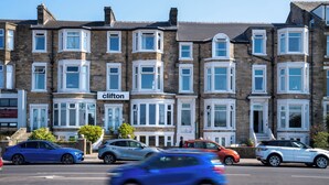 A row of terraced houses with a sign reading "The Clifton". - The Clifton Hotel (Morecambe)