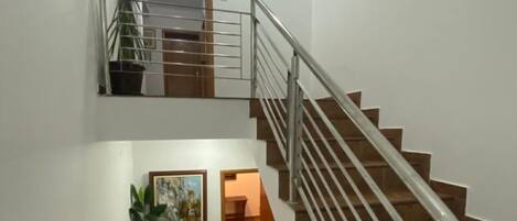 A staircase with metal railings and wooden steps.