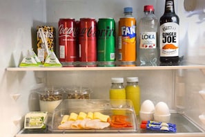 Un frigorifero fornito di bevande, salse e alimenti.