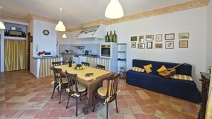 A compact living space with a dining area, kitchen, and seating area.