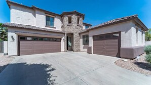 A two-story house with a stone tower, two garages, and a large driveway. - Bella Bella!  Heated Pool/HotTub/Sauna/BBQ (Casa Grande)