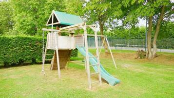 Explore the fun of this park play structure featuring a slide and climbing ladder.