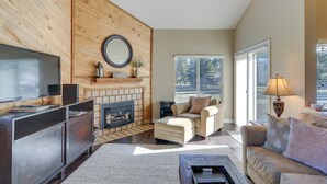 A living room with a fireplace, a television, and a sofa. - Dog-friendly Pagosa Springs Condo Near Hot Springs (Pagosa Springs)