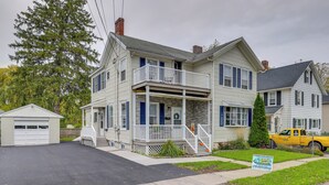A two-story house with a front porch, a garage, and a driveway. - Central Auburn Apartment w/ Porch: Pets Welcome! (Auburn)