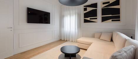 Deluxe Apartment | Living area | 40-inch flat-screen TV with digital channels