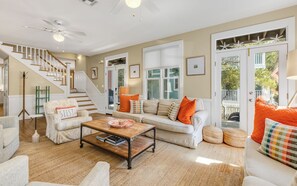 A spacious living room with a staircase, a sofa set, and a coffee table.
