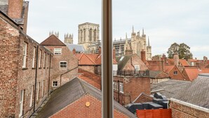A view of a cityscape with historic buildings and a prominent cathedral in the background. - 6 Granary Court (York)