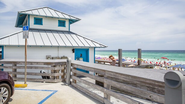 A beachside building with a ramp and a wheelchair-accessible sign. - Summerspell 304 - Gulf View, Swimming Pool, Hot Tub, Walk to the Beach + Dining! (Miramar Beach)