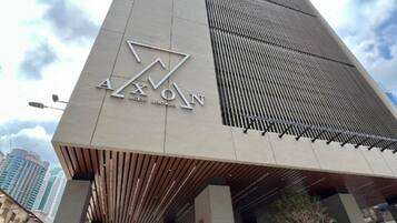 A modern building with a prominent logo and a sloped roof design.