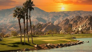 A golf course with a water body, palm trees, and mountains in the background. - Perfect Palm Springs Studio Retreat Near Downtown!
 (Palm Springs)