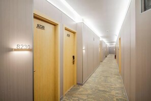 A hotel hallway with doors numbered 8230 and 8231, carpeted with a geometric pattern, and a ceiling with recessed lighting. - Aoyou Esports Hotel (Shanghai Lujiazui) (Shanghai)