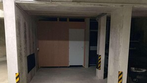 A parking garage with concrete pillars, a door, and the number 'A21' painted on the floor. - 140m from ski lifts, balcony, tv, 27m², Morzine (Morzine)