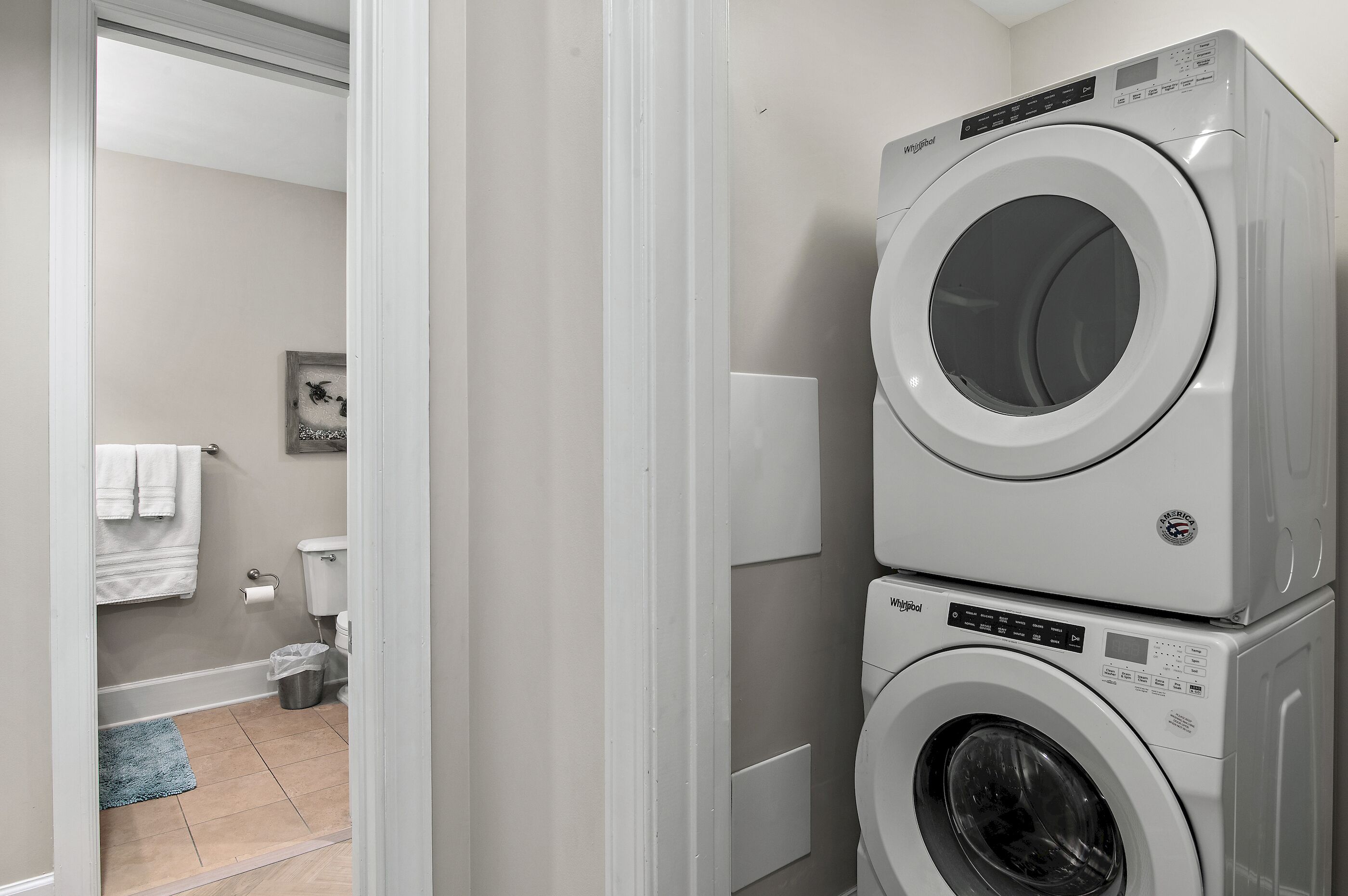 A laundry room with two stacked front-loading washing machines.